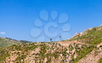 Mountains under bright blue sky. South part of Corsica island, France. Natural landscape