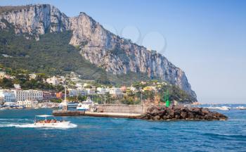 Entrance of Capri port, Italy. Breakwater with green lighthouse
