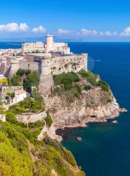 Vertical landscape of old town Gaeta with ancient castle on coastal rock, Italy