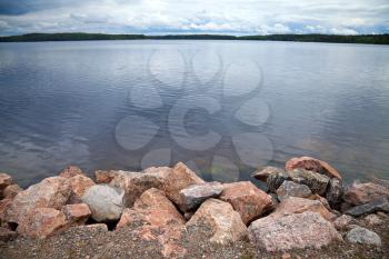 Coast of lake with granite stones,  Imatra town, Finland