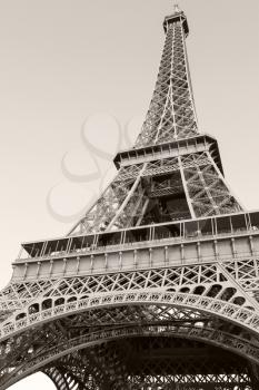 Looking up on Eiffel Tower, the most popular landmark of Paris, France. Monochrome vertical photo