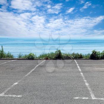 Empty parking place on the sea coast in summer day