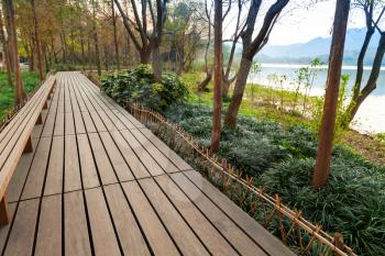Wooden pathway. Walking around famous West Lake park in Hangzhou city center, China