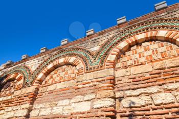 Old stone wall with ancient pattern and clear blue sky, Church in Nessebar town, Bulgaria