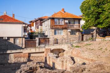 Street view of Nesebar, Bulgaria. Typical revival houses and ancient Roman ruins in the old town