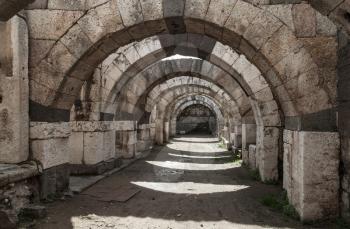 Empty corridor with arcs and columns. Ruins of Ancient city Smyrna. Izmir, Turkey