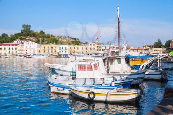 Moored small fishing boats in old Ischia port, Italy