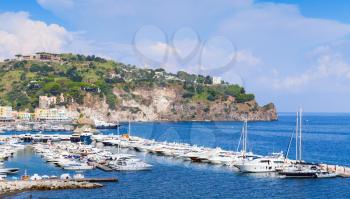 Yacht and pleasure boats moored in marina of Lacco Ameno, Ischia island, Italy