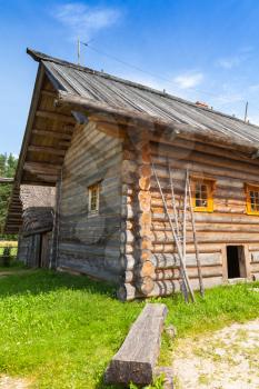 Russian rural wooden architecture example, old bench stands near house