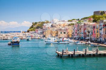 Small Italian town cityscape with colorful houses and piers. Port of Procida island, Gulf of Naples, Italy