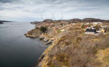 Traditional coastal Norwegian village with colorful wooden houses on rocks