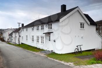 Street with small white wooden houses in Norwegian town