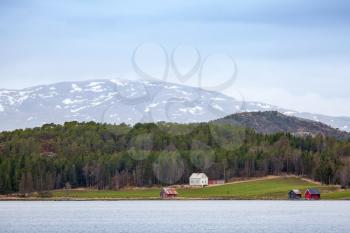 Traditional Norwegian rural landscape, wooden houses and barns on seacoast