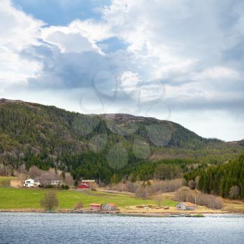 Traditional Norwegian small village landscape, colorful wooden houses and barns on the North Sea coast