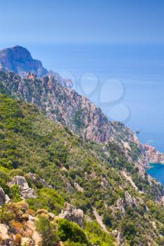 Corsican rocks and sea in summer. Landscape of French mountainous Mediterranean island Corsica. Corse-du-Sud, Piana. Vertical photo
