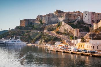 Bonifacio port in warm morning sunlight, mountainous Mediterranean island Corsica, Corse-du-Sud, France