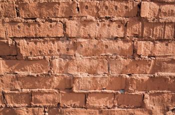 Old grungy red brick wall, close-up background photo texture