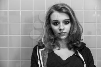 Caucasian blond teenage girl portrait. Stylized black and white photo with old style effect