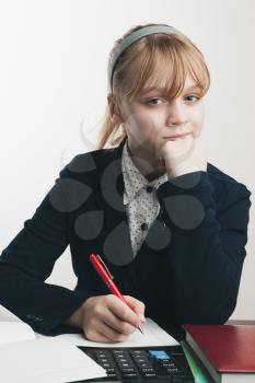 Sitting school girl, closeup portrait over white wall background
