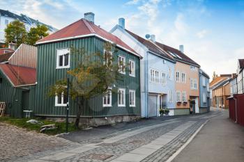 Traditional Scandinavian wooden living houses stand along old street in Trondheim, Norway