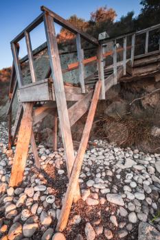 Old wooden stairs going to the beach. Vertical photo. Zakynthos island, Greece