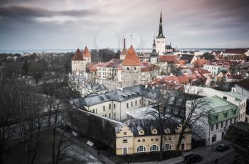 Old town of Tallinn, aerial panorama. Churches and living houses with red roofs. Vintage toned photo