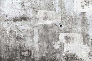 Grungy empty concrete wall with white paint brush strokes, background texture