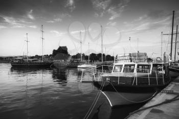 Old boats stand moored in port of Nesebar, Bulgaria. Black and white photo