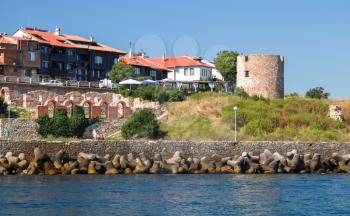 Seaside landscape of old town Nesebar, Bulgaria. Black Sea coast, ruined old stone watch tower on the hill