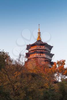 Ancient pagoda on the coast of West Lake. Famous public park in Hangzhou city, China
