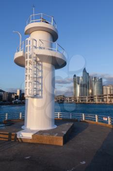 White lighthouse tower in fishing port of Busan, South Korea