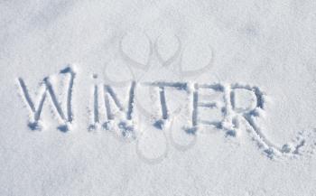 Winter. Hand drawn text over fresh snow 