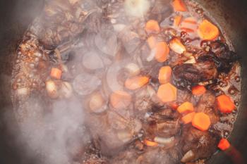 Lamb with carrot and onion stew in a cauldron. Preparing of Chorba soup