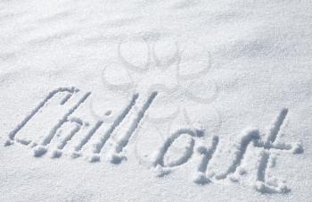 Chill out. Hand drawn text on fresh snow 