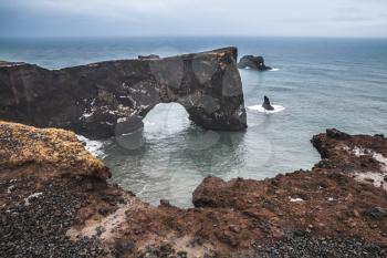 Rocky arch. Scenic landscape of Dyrholaey Nature Reserve, south coast of Iceland