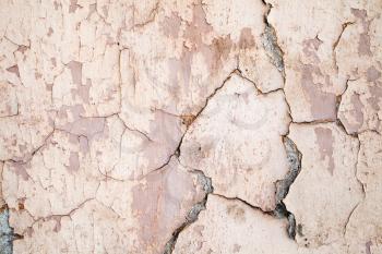 Grunge metal wall with peeling paint layers, close-up background photo texture