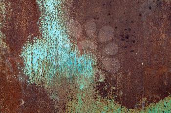 Old green grunge metal wall with big rust spots, close-up background photo texture