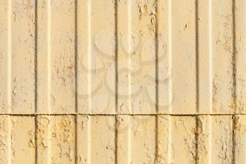 Old yellow corrugated metal wall, frontal background photo texture
