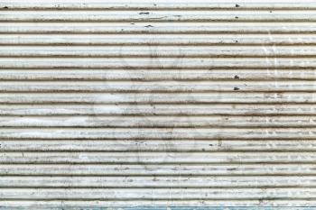Old white grungy corrugated metal wall, frontal background photo texture