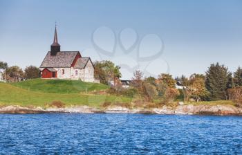 Norway. Edoya island landscape with historic parish church, it was built around the year 1190