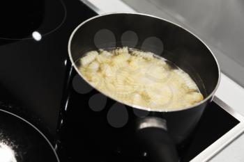 Boiling water with Fusilli pasta in the steel pan