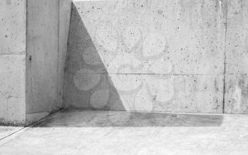 Abstract concrete interior fragment. Shadow cowers corner of gray stone walls and floor