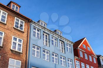 Colorful houses under blue sky in a row, traditional architecture style of Copenhagen old town, Denmark