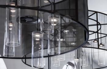 Contemporary interior design fragment, chandelier with round glass lampshades and white LED lights