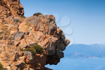 Face shaped coastal rocks of Corsica island. Viewpoint of Capo Rosso, Piana region
