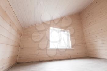Empty attic room interior, new wooden walls and window