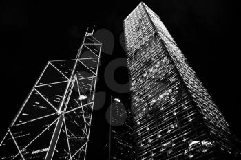 Skyscrapers under dark night sky, high-rise office buildings of Hong Kong city. Black and white photo