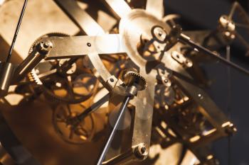 Vintage world clock mechanism, fragment with shiny brass gears