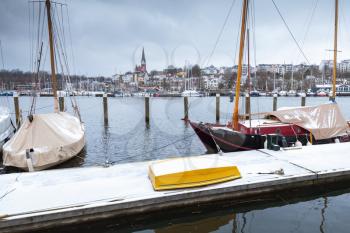 Sailing yachts moored in marina of Flensburg, Germany in winter season