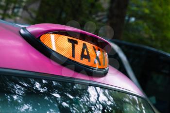 Illuminated taxi label mounted in pink roof of London cab
